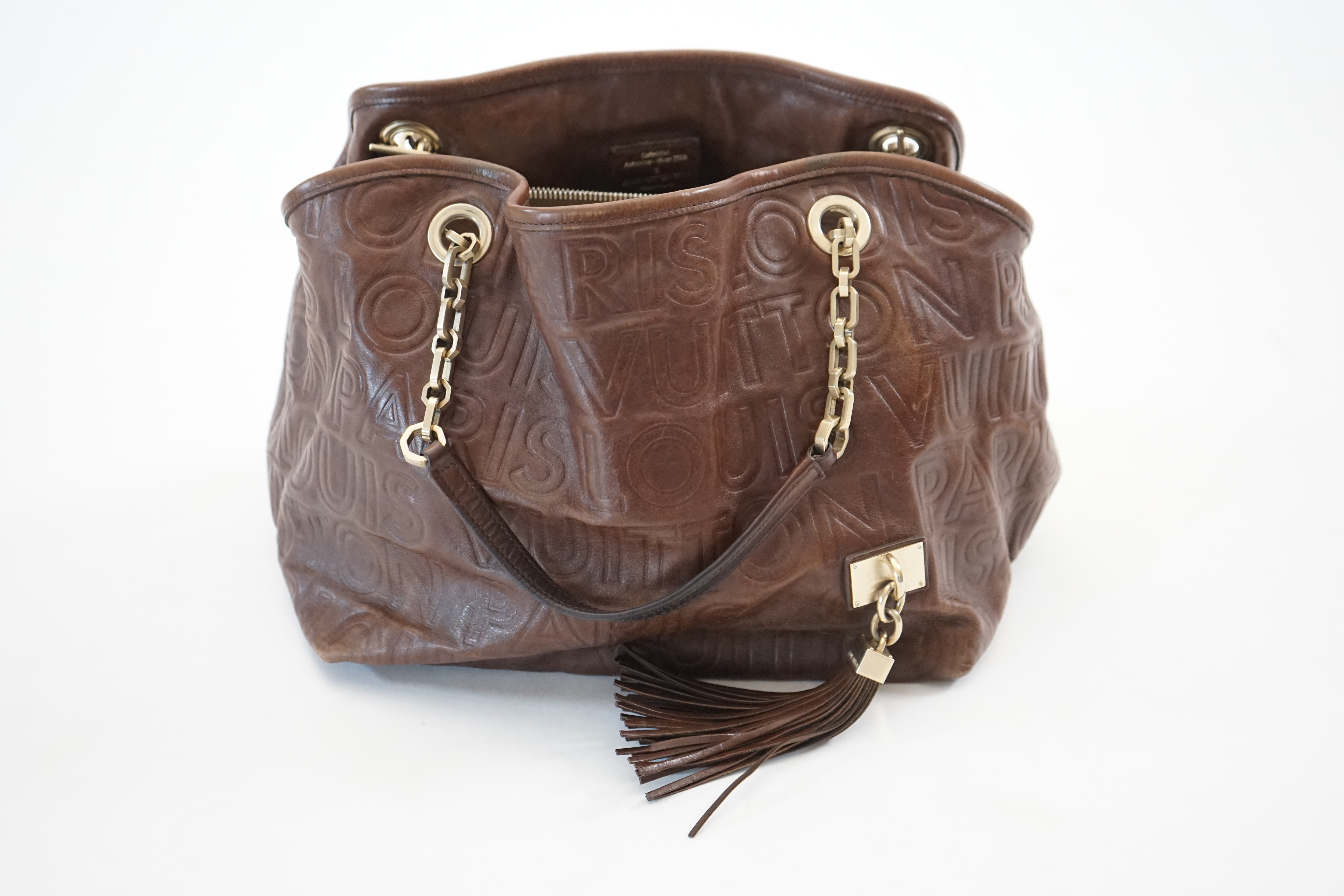 A Louis Vuitton Whisper brown leather handbag, width 31cm, depth 22cm, approx height 26cm